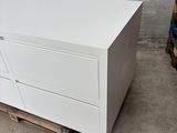 a white chest of drawers on a pallet in a warehouse