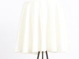 a close up of a table lamp with a white table cloth on it