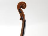 a close up of a violin on a stand against a white background