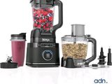 a blender with a blender and a blender filled with fruit