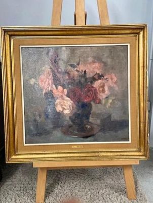 a painting of flowers in a vase on a easel