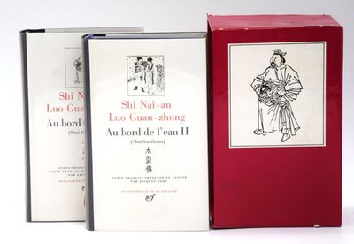 two books are sitting on a white surface one is red and the other is white