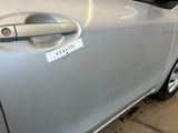 a silver car that has a sticker on the door handle