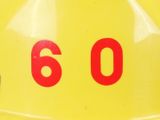 a yellow hard hat with a red number on it