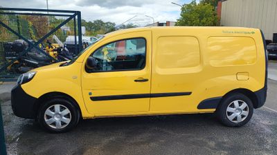 the yellow van is parked in the parking lot next to other vehicles