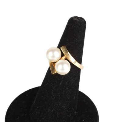 un gros plan d'une bague ornée de deux perles