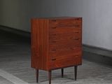 a small chest of drawers sitting on a wooden floor