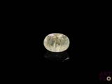 a close up of a green diamond on a black surface