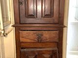 une grande armoire en bois au milieu d'un sol carrelé