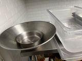 a large metal bowl sitting on top of a metal counter