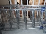 a picture of a metal gate with wheels on it