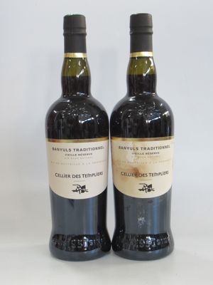 two bottles of wine sitting next to each other on a table