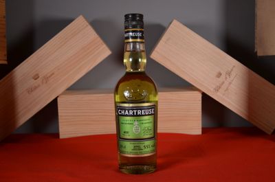 a bottle of whisky sitting on a table next to wooden blocks