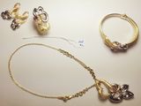 a necklace, bracelet, and ring laying on a table