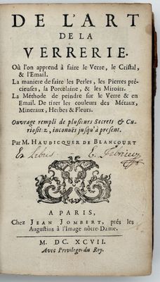 an old book with a black and white drawing on it