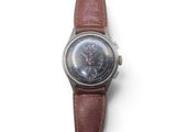 wrist watch with brown leather strap on a white surface