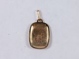 an image of a small gold pendant with a rectangular design