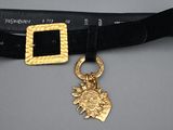 black velvet belt with a gold buckle and a gold bee charm
