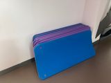 purple and blue file folders sitting on the floor in front of a white wall