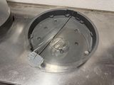 a metal pan on a metal counter with a spatula in it