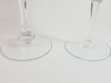 two wine glasses sitting next to each other on a table