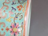 a blue vase with a floral design on it