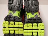 the soles of a pair of running shoes on a white surface