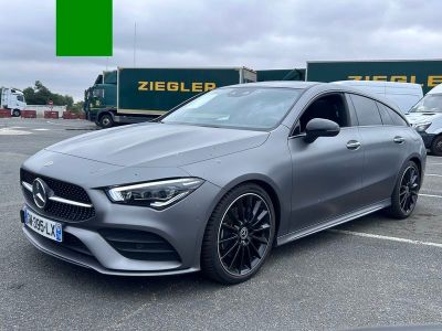 a grey mercedes cla is parked in a parking lot