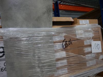 a large stack of boxes sitting on a pallet in a warehouse