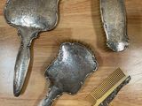 trois types différents de brosses à cheveux et un peigne posés sur une table