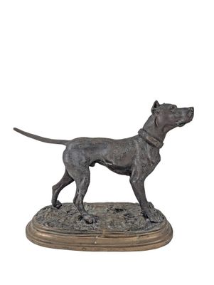 bronze statue of a dog standing on a wooden base