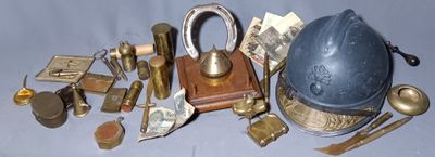 a collection of antique brass items including a clock, a keychain, and other items