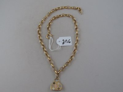 a close up of a necklace with a gold chain and a heart charm