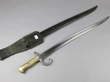 a knife that is laying next to a knife on a table