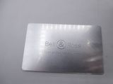 a close up of a metal business card on a white surface