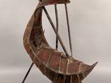 sculpture of a boat made of wood and metal on a white surface