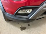 a close up of a red car parked in a garage