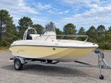 a boat that is parked on a trailer in the parking lot