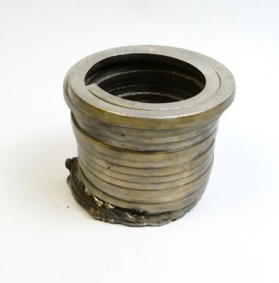 a metal object that is sitting on a white surface