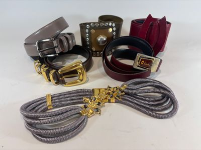 a lot of belts and bracelets on the table
