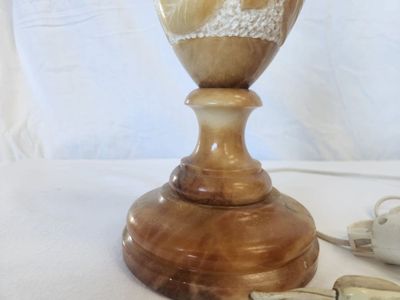 a vase that is sitting on a table next to a tea cup