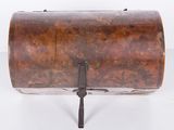 an old wooden barrel with a metal handle on a white surface