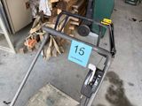 a lawn mower that is sitting on the ground