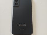a close up of a black samsung phone sitting on a table