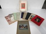 several books sitting on top of a white table next to each other