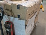 boxes stacked on a dolly in a large warehouse with a hand truck