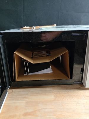 a microwave that has a bunch of boxes inside of it