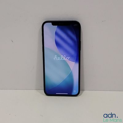 the back of a black phone sitting on top of a white table