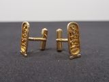 pair of gold plated cufflinks with an image of a man and a woman