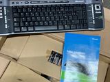 a keyboard and a book sitting on top of a cardboard box
